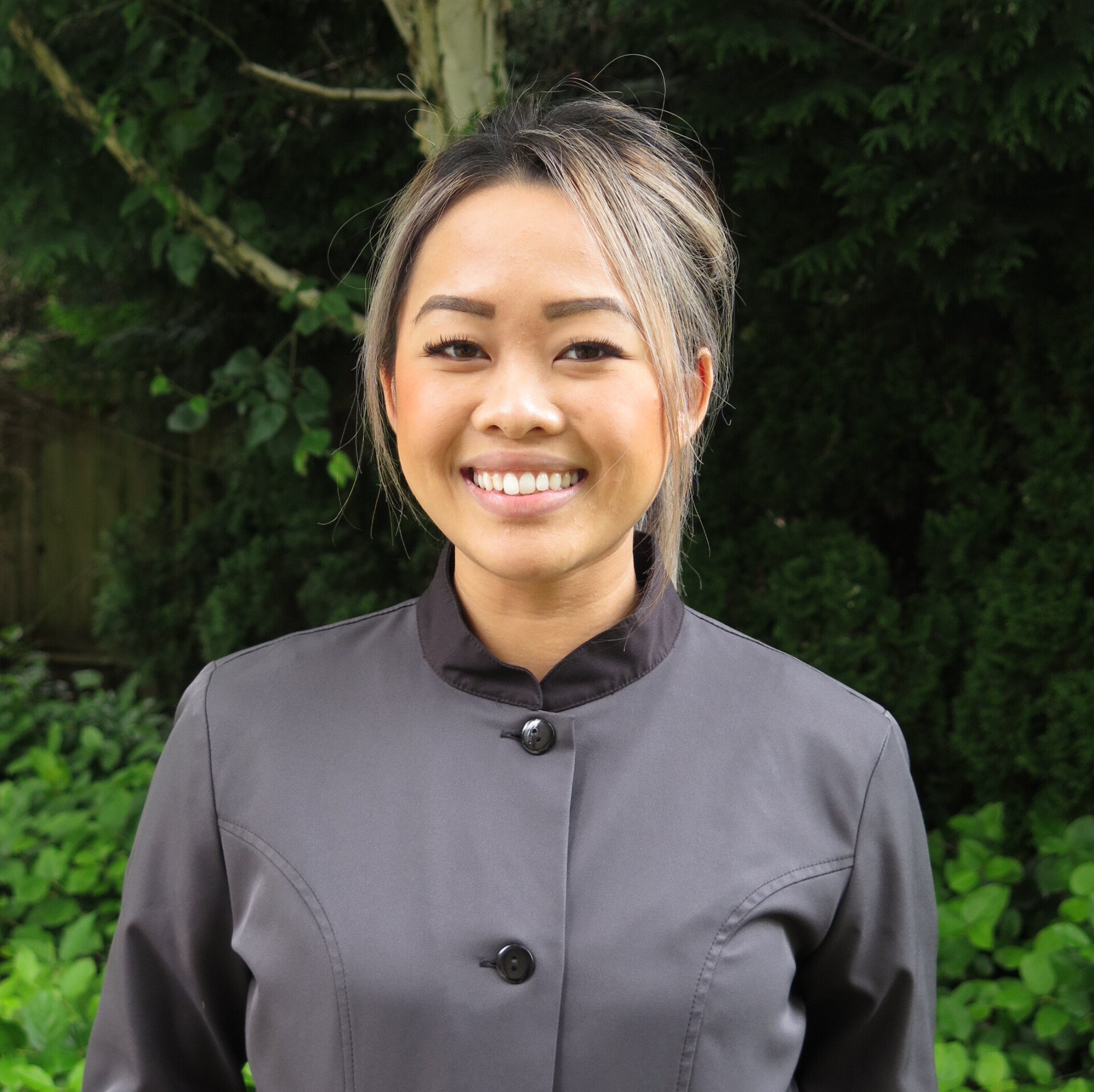 Tara, a Registered Dental Hygienist at our Bellevue Dental Office, beaming with a friendly expression in her photo.