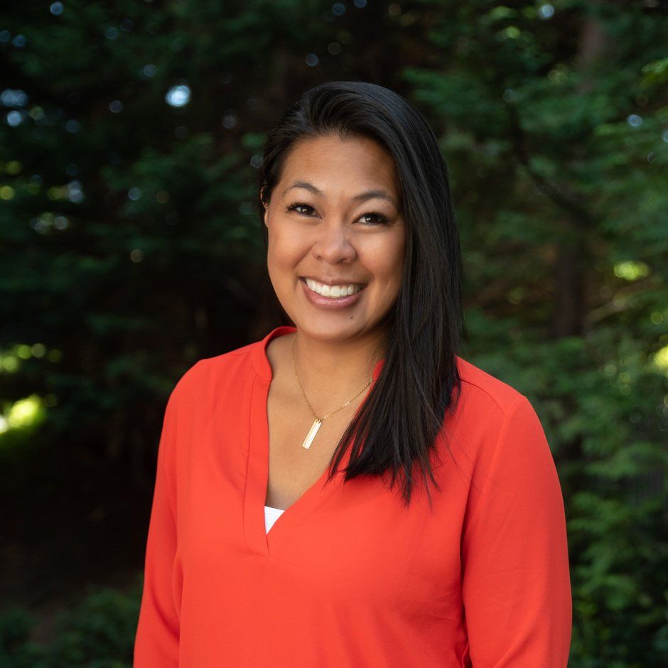 Eden, the Patient Care Coordinator at our Bellevue Dental Office, smiling warmly for a picture.