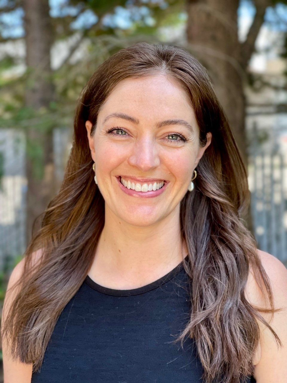 Jamie, our Financial Coordinator at our Bellevue Dental Office, grinning with a friendly demeanor.