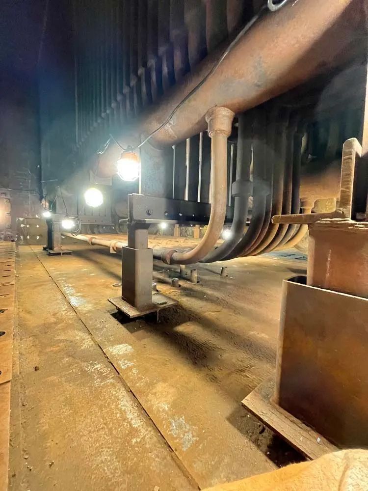 A close up of a metal structure in a factory at night