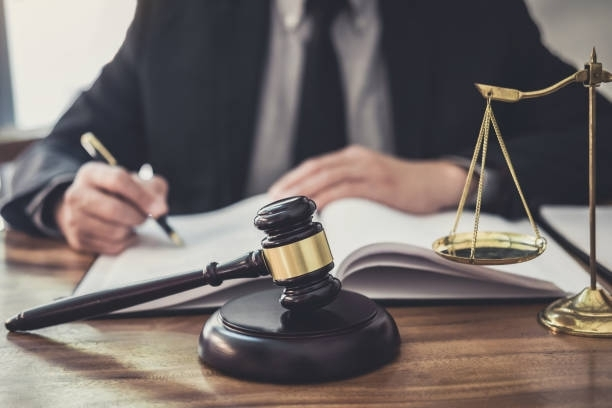 Tesoroni & LeRoy Immigration Attorney in Elizabeth, NJ, reviewing legal documents with gavel and sca