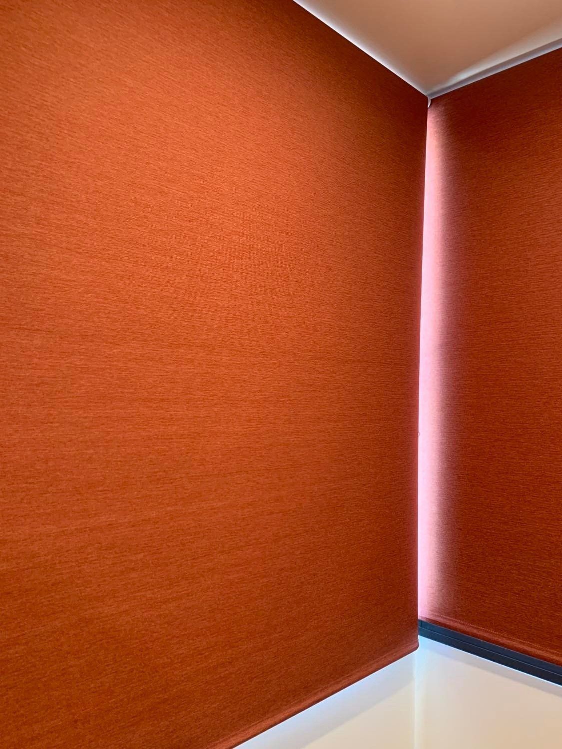 Orange Textured Roller Shades in The Corner of A Room — Alice Mobile Blinds in Ciccone, NT