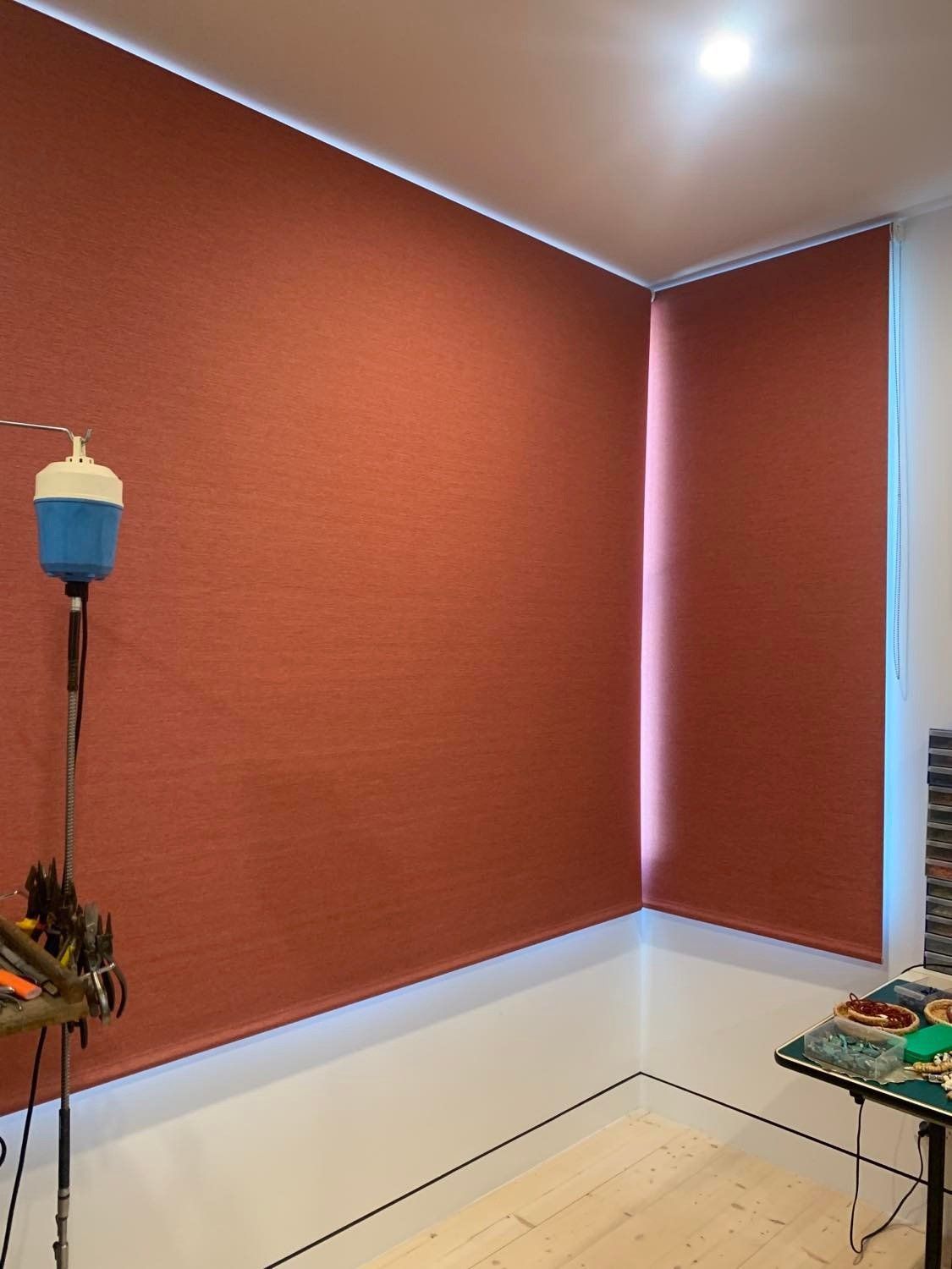 Room with Terracotta-Coloured Blinds Covering Two Walls — Alice Mobile Blinds in Ciccone, NT