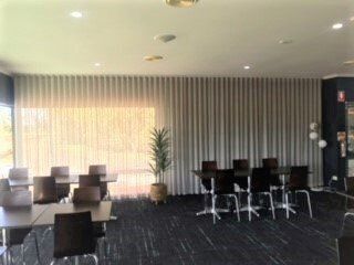 Interior of A Room with Tables, Chairs, Curtains and A Plant — Alice Mobile Blinds in Ciccone, NT