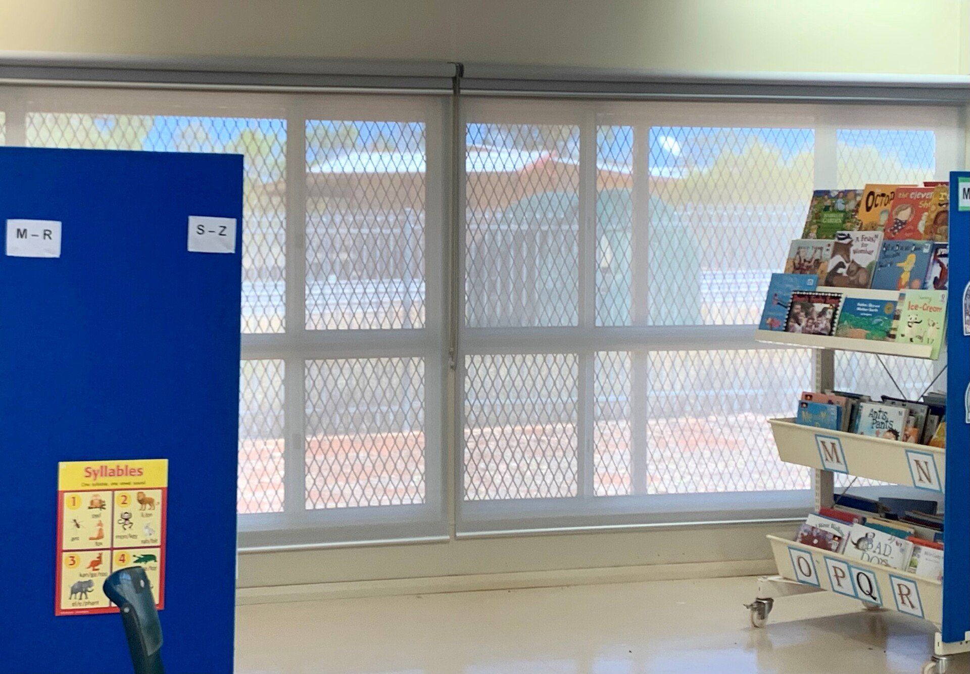 Classroom with Blue Bulletin Board, Window and Book Shelves — Alice Mobile Blinds in Ciccone, NT