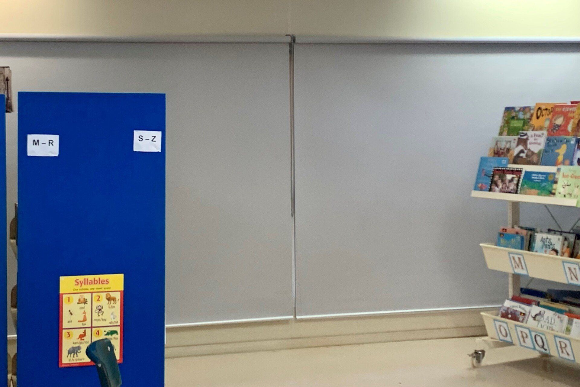 Blue Bulletin Board Next to A Bookshelf in A Classroom — Alice Mobile Blinds in Ciccone, NT