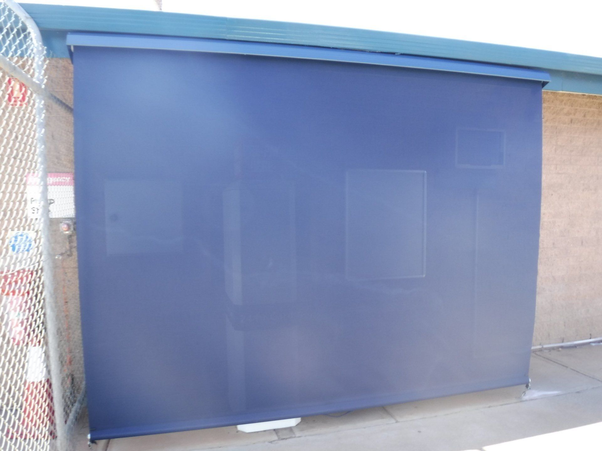 Blue Outdoor Shade Covering a Building Entrance — Alice Mobile Blinds in Ciccone, NT