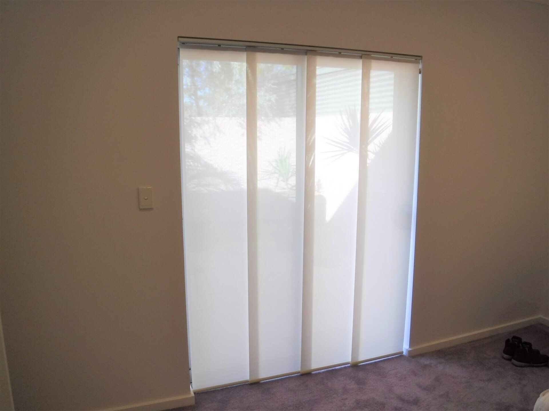 Panel Track Blinds on A Sliding Glass Door in A Room — Alice Mobile Blinds in Ciccone, NT