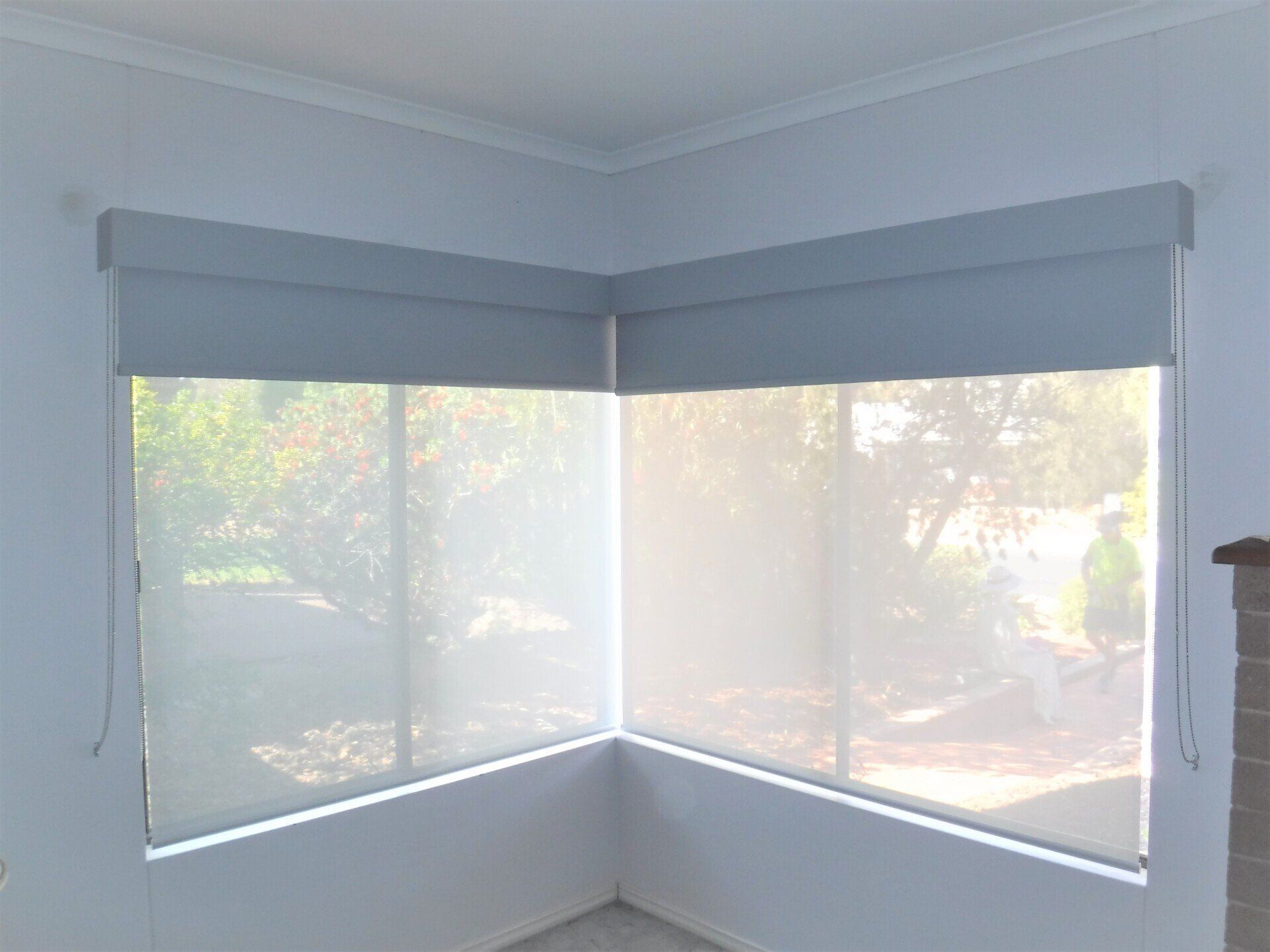 Corner Window with Grey Roller Blinds — Alice Mobile Blinds in Ciccone, NT