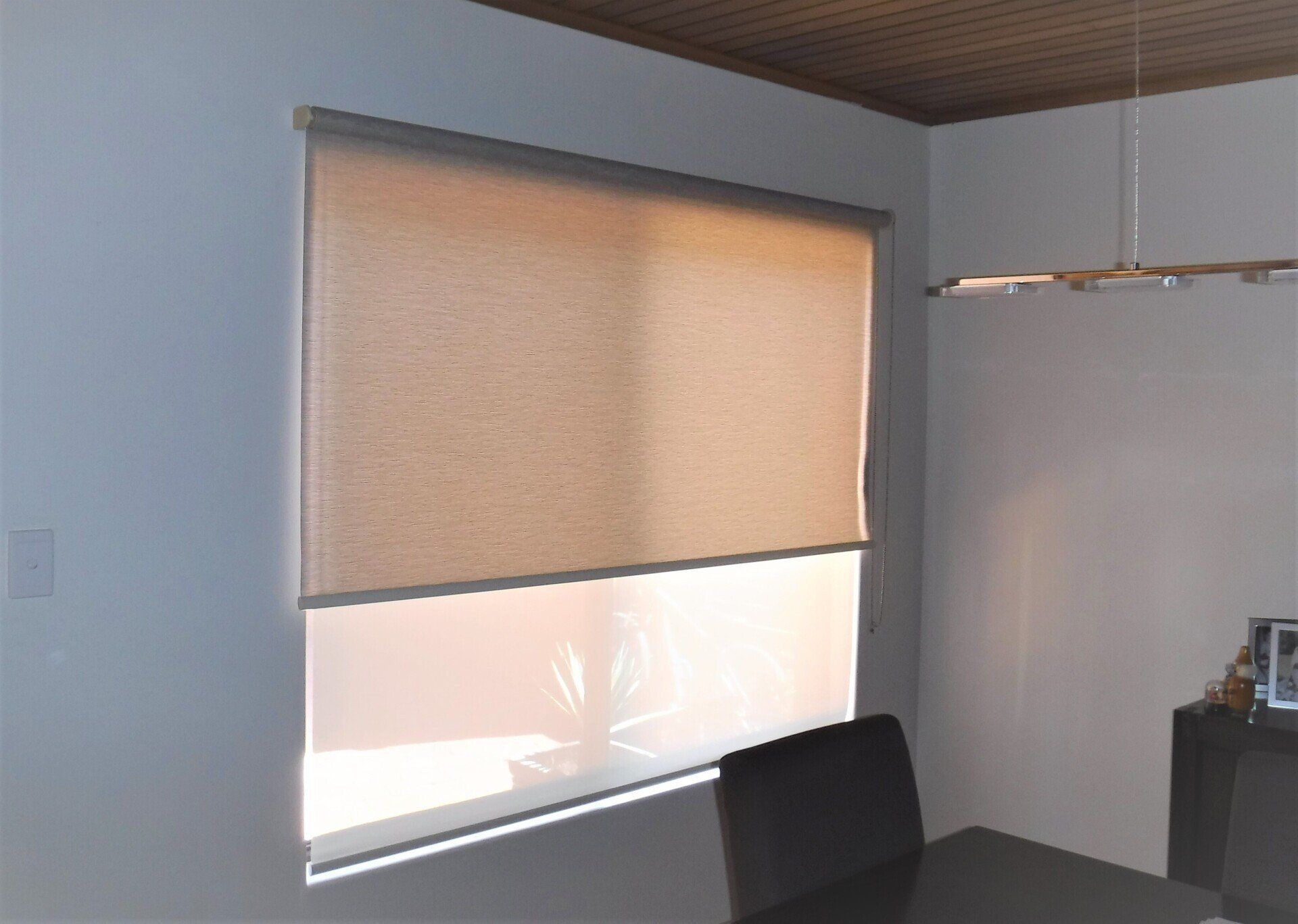 Beige and White Roller Shades Cover a Window in A Room — Alice Mobile Blinds in Ciccone, NT