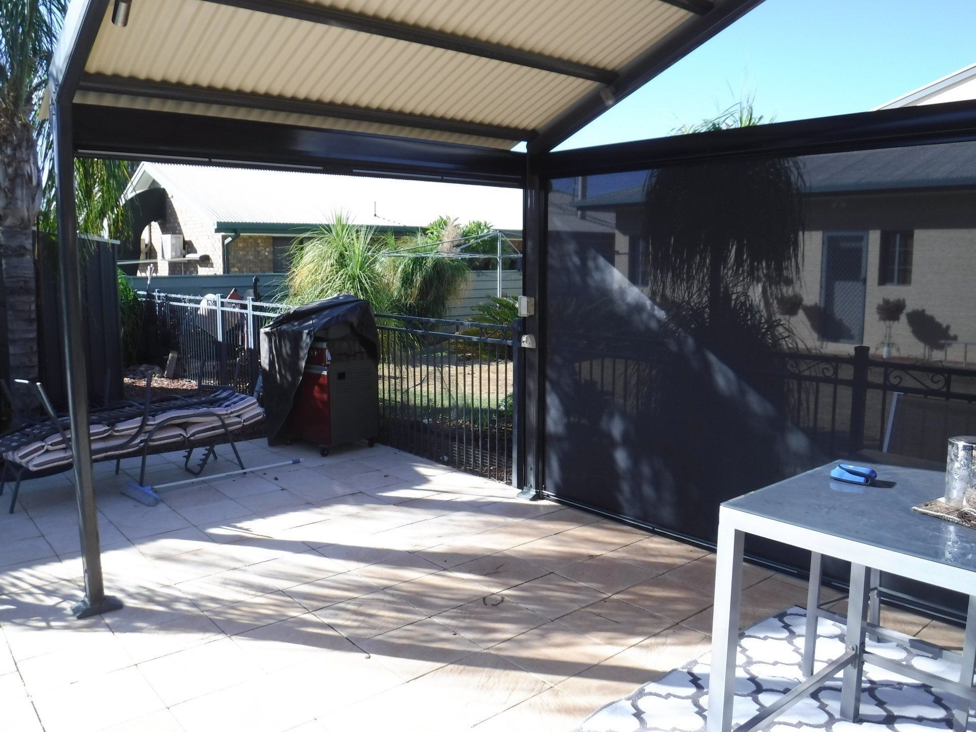 Patio with Black Canopy, Roll-Down Shade, Table, and Grill — Alice Mobile Blinds in Ciccone, NT