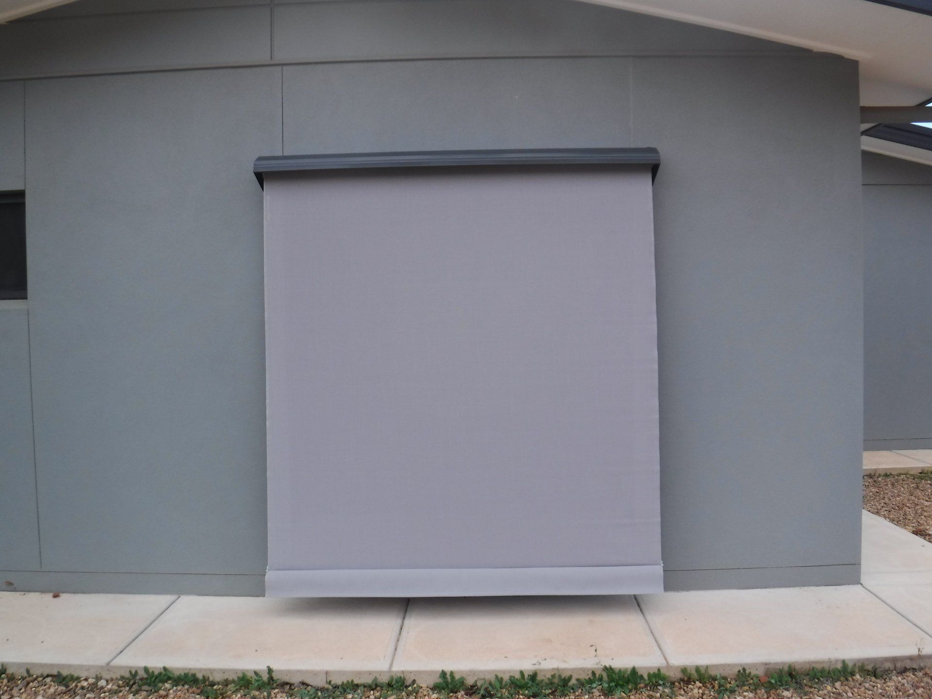 Grey Shade Rolled Halfway Down on A Grey Wall — Alice Mobile Blinds in Ciccone, NT