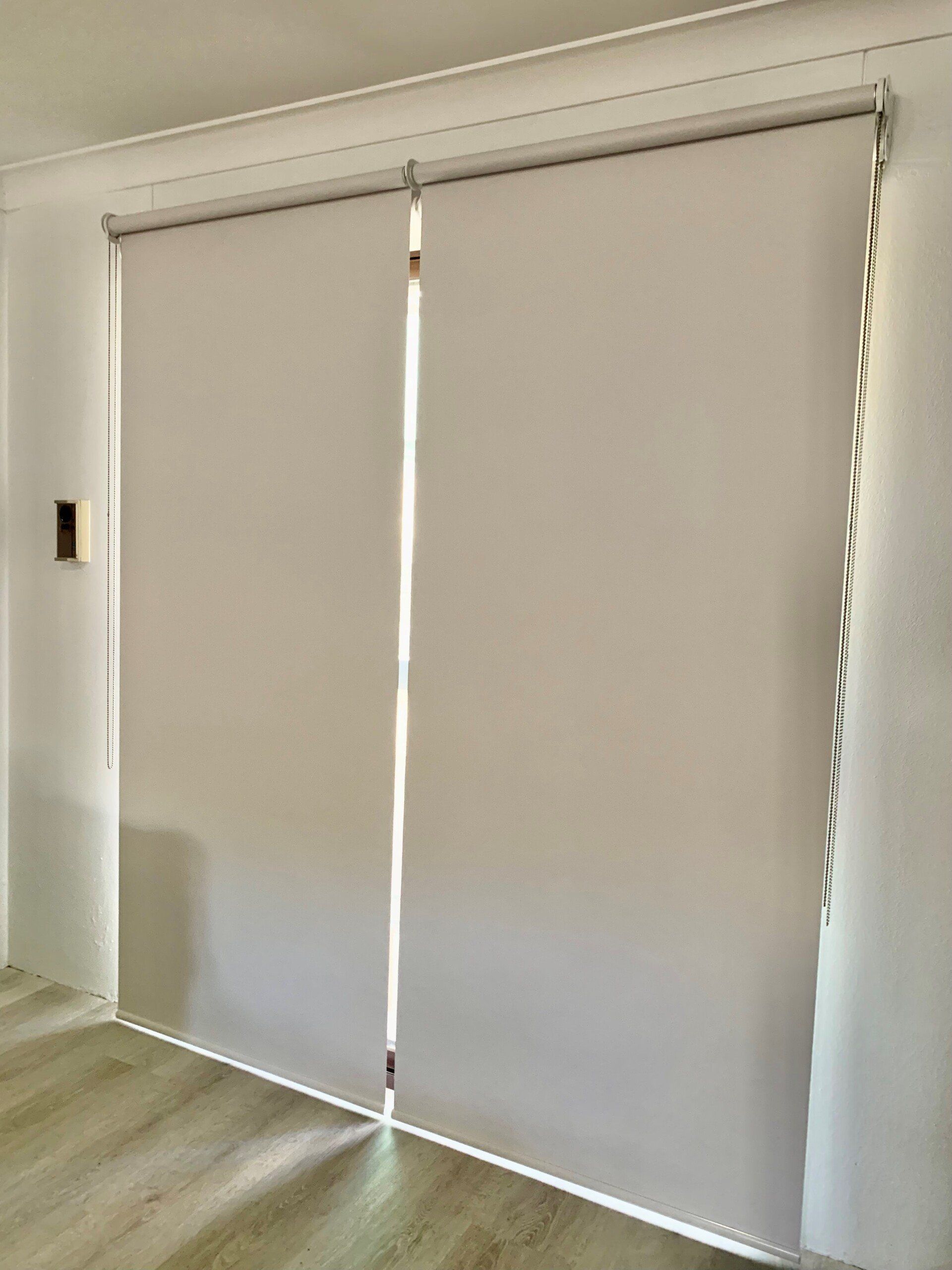 Two White Roller Blinds Partially Drawn Covering a Doorway — Alice Mobile Blinds in Ciccone, NT
