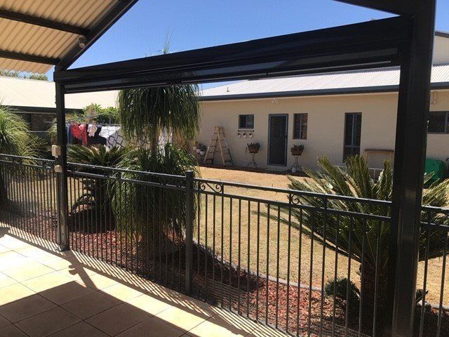 Patio Overlooking a Backyard with Plants — Alice Mobile Blinds in Ciccone, NT