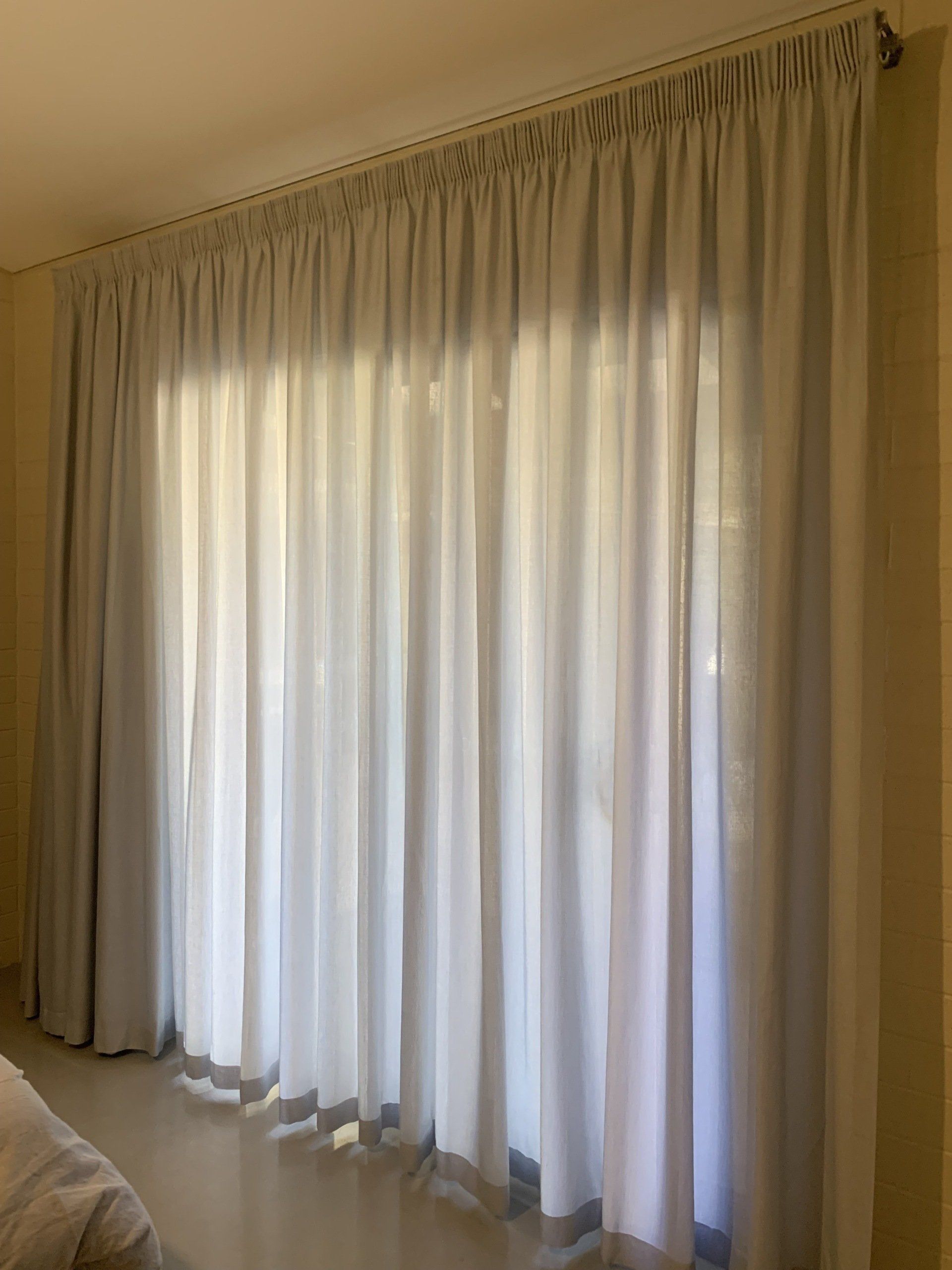 Light Grey Sheer Curtains Hanging Over a Window — Alice Mobile Blinds in Ciccone, NT