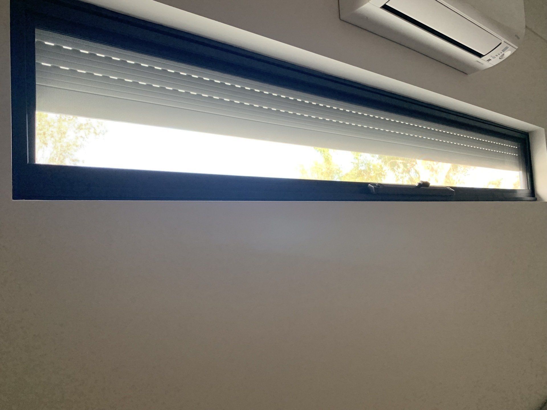 A Long Rectangular Window with A Roller Shutter — Alice Mobile Blinds in Ciccone, NT