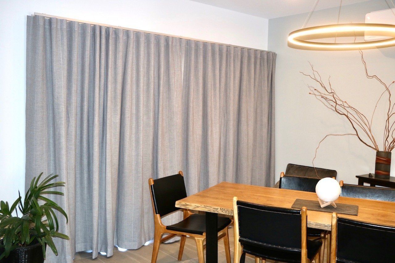 Grey Curtains in A Dining Room, Wooden Table with Black Chairs — Alice Mobile Blinds in Ciccone, NT