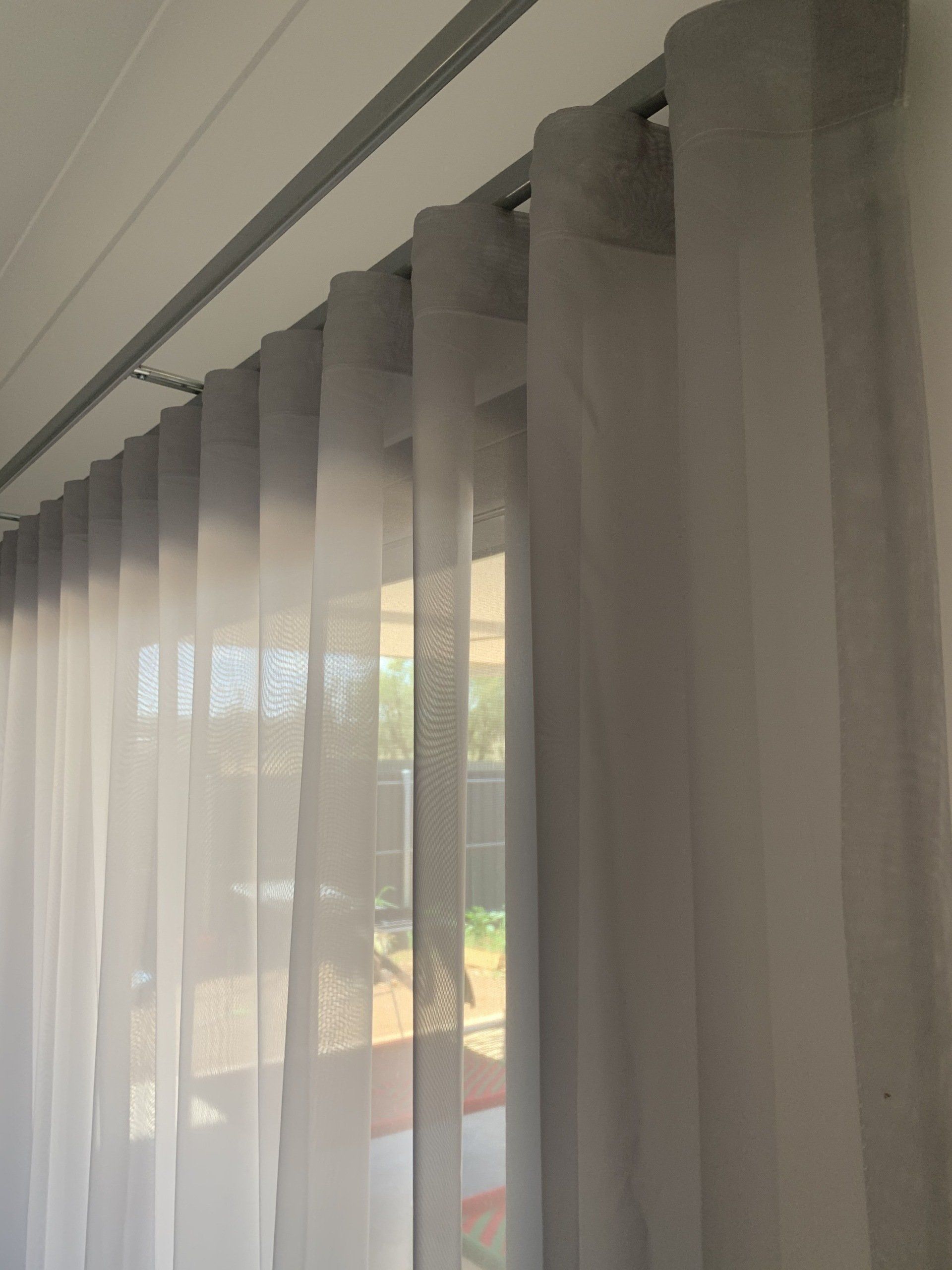 Grey Sheer Curtains Hanging from A Track — Alice Mobile Blinds in Ciccone, NT