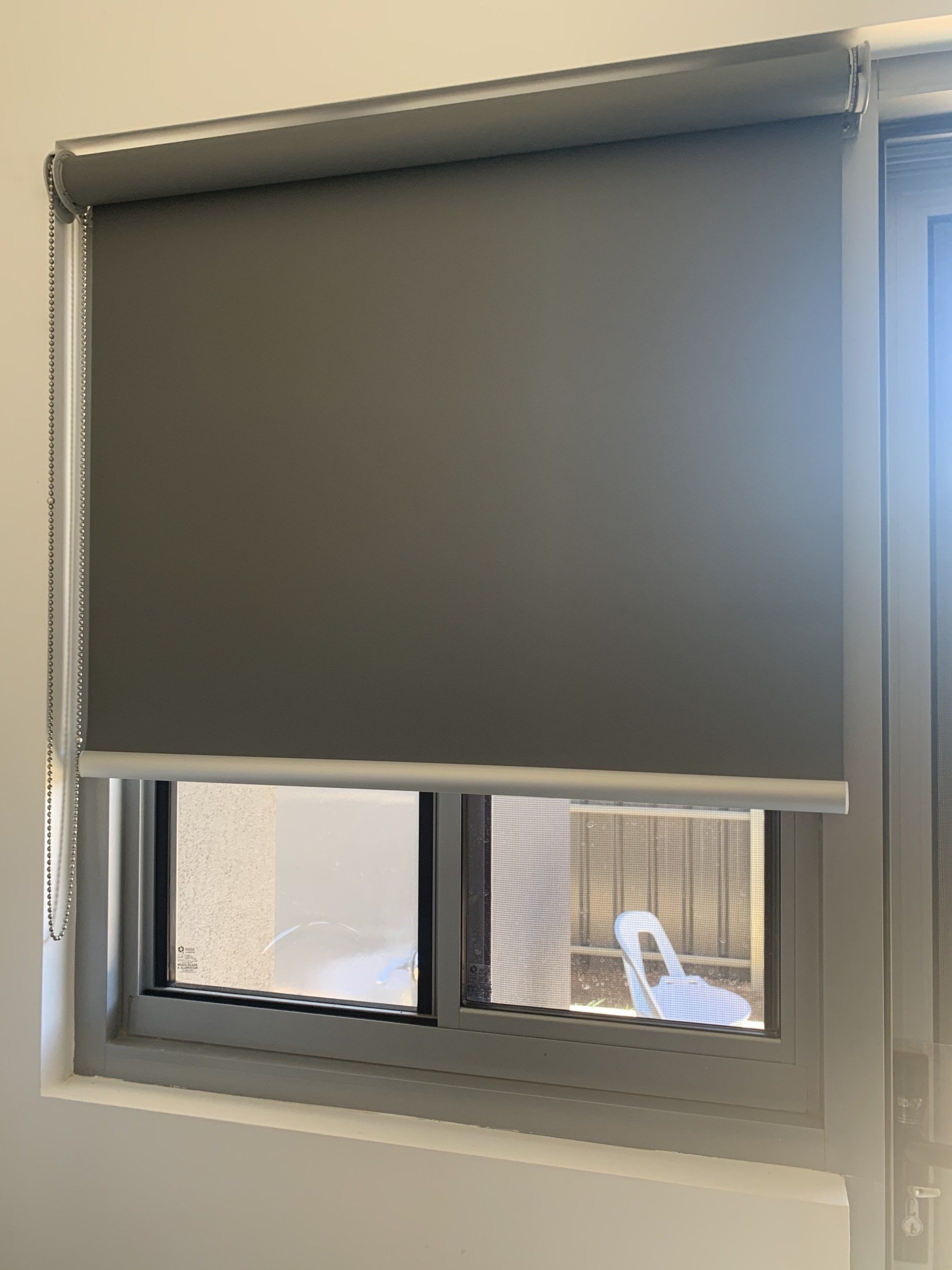 Grey Roller Blind Partially Covering a Window — Alice Mobile Blinds in Ciccone, NT
