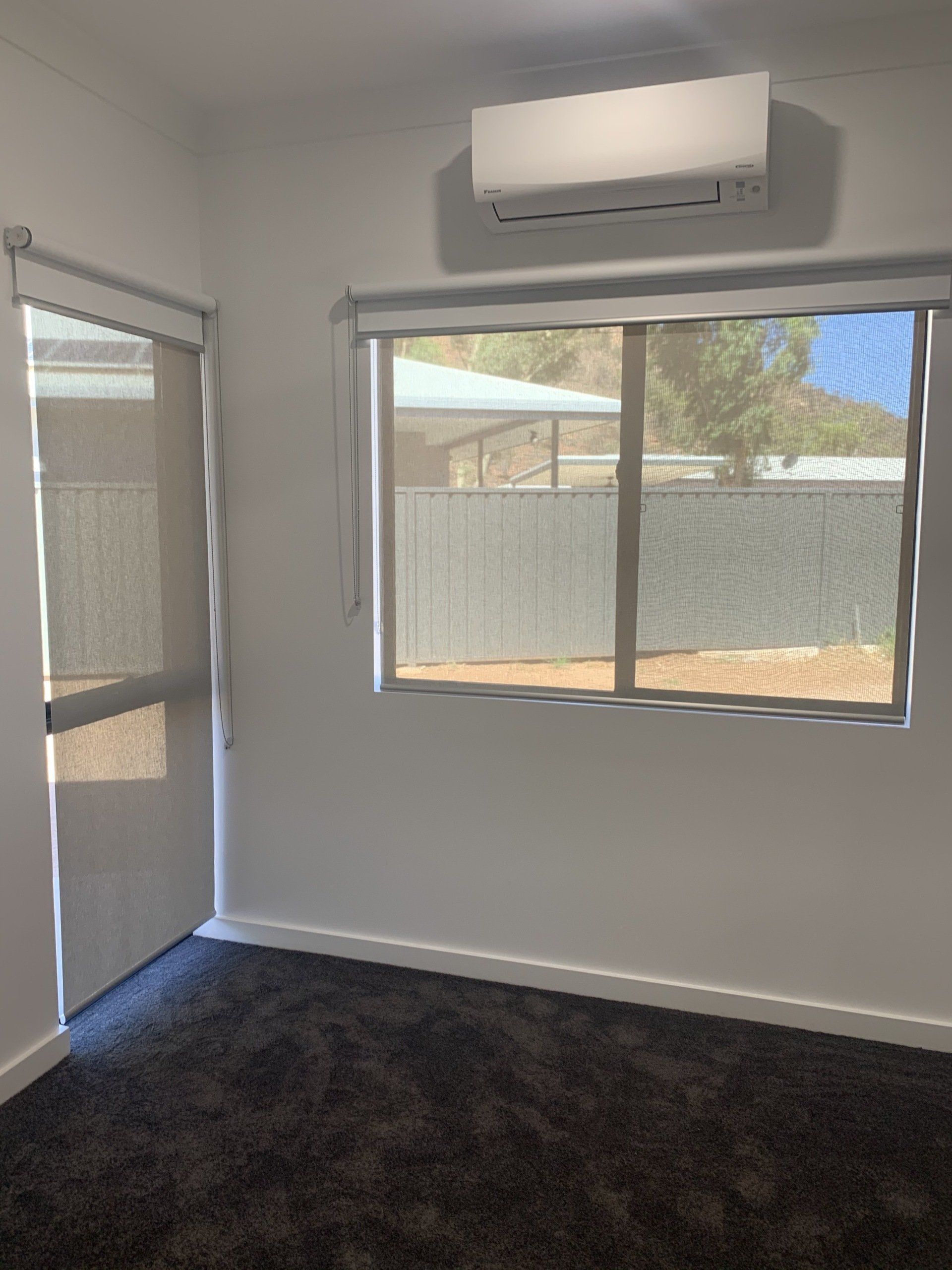 Empty Room with Dark Carpet, White Walls and Blinds — Alice Mobile Blinds in Ciccone, NT