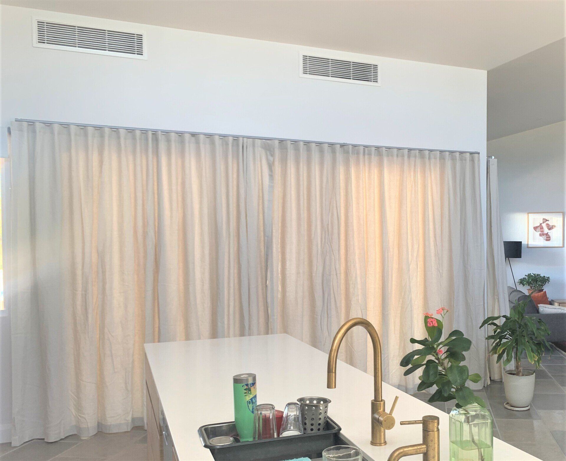 Kitchen with White Countertop, Brass Faucet and White Curtains — Alice Mobile Blinds in Ciccone, NT