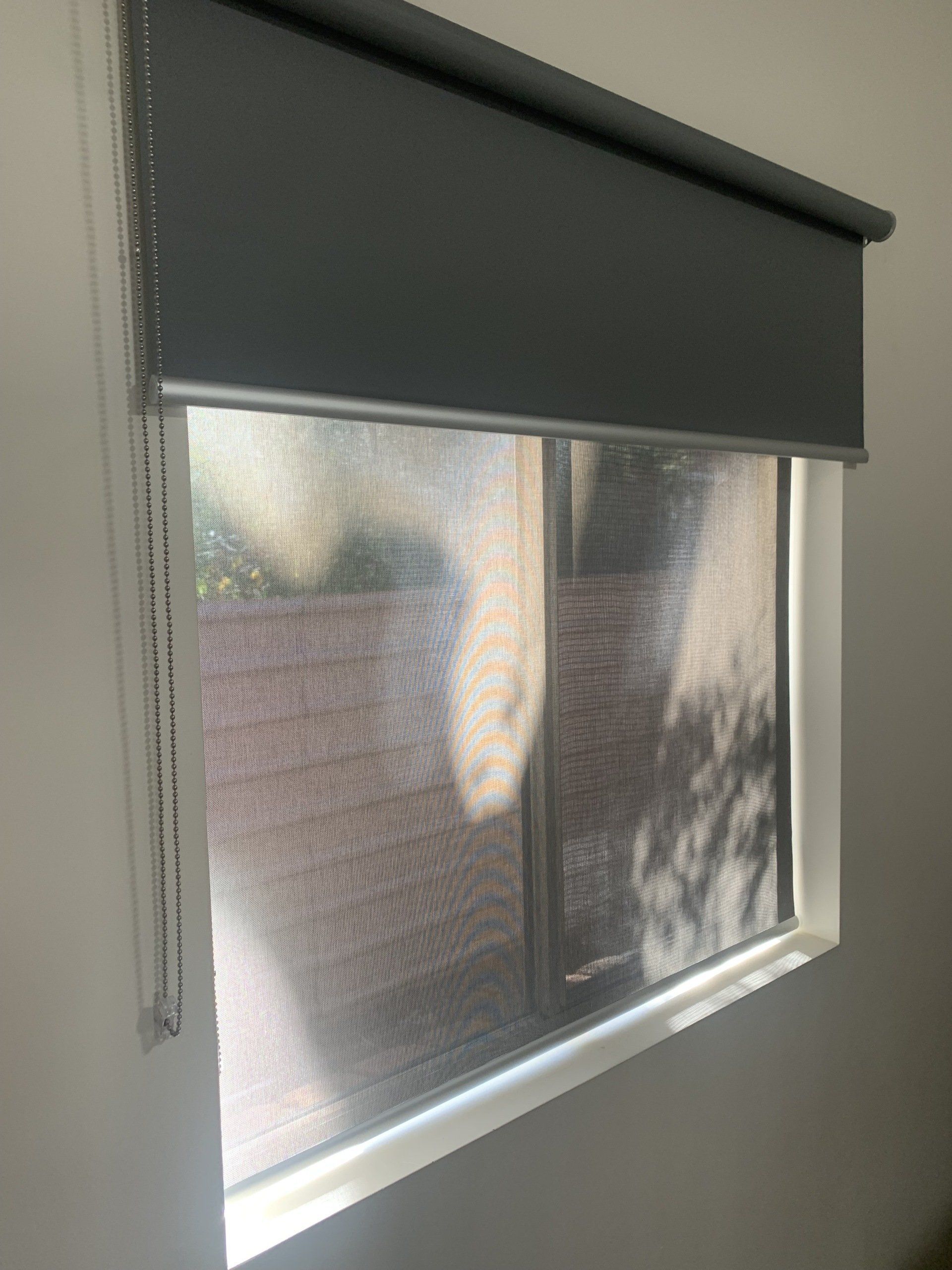 Grey Roller Blinds Partially Covering a Window — Alice Mobile Blinds in Ciccone, NT