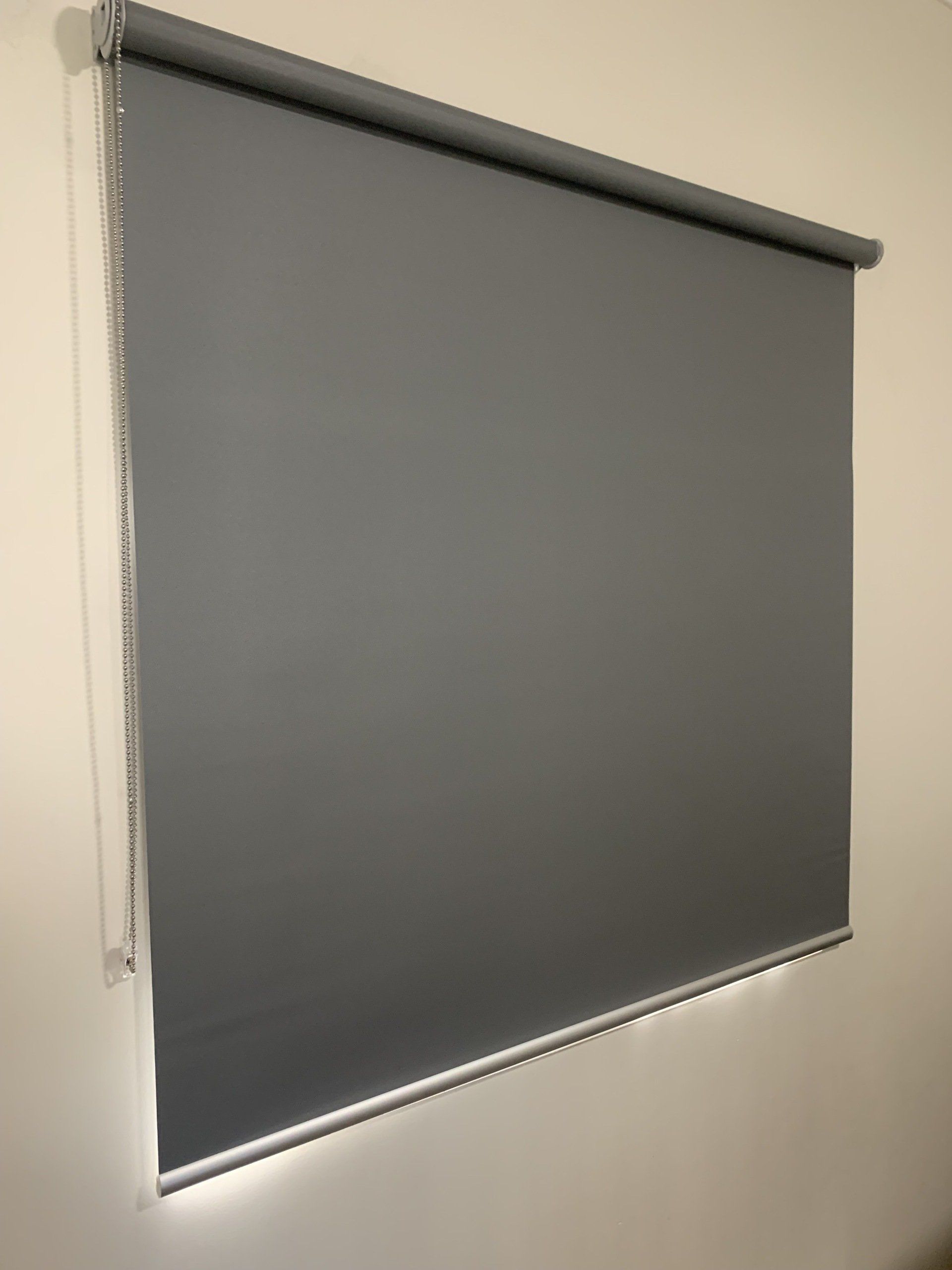 Grey Roller Blind on A Light-Coloured Wall — Alice Mobile Blinds in Ciccone, NT