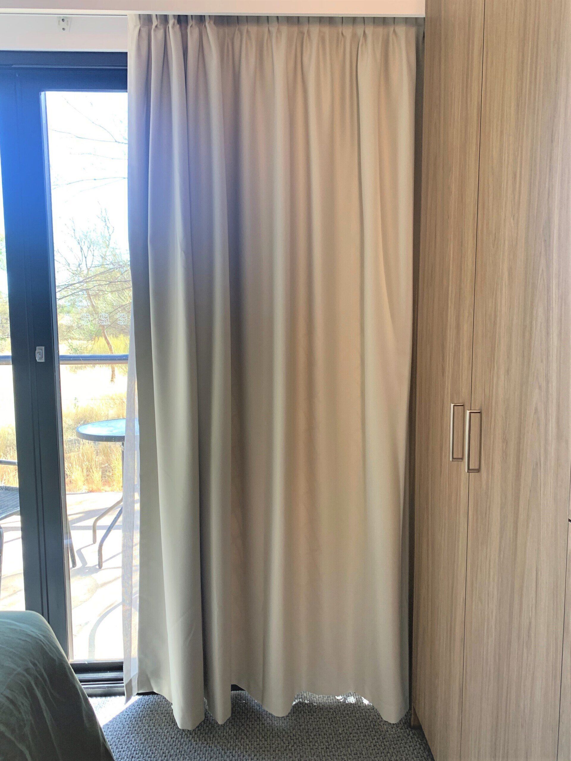Beige Curtain Beside a Closed Door — Alice Mobile Blinds in Ciccone, NT