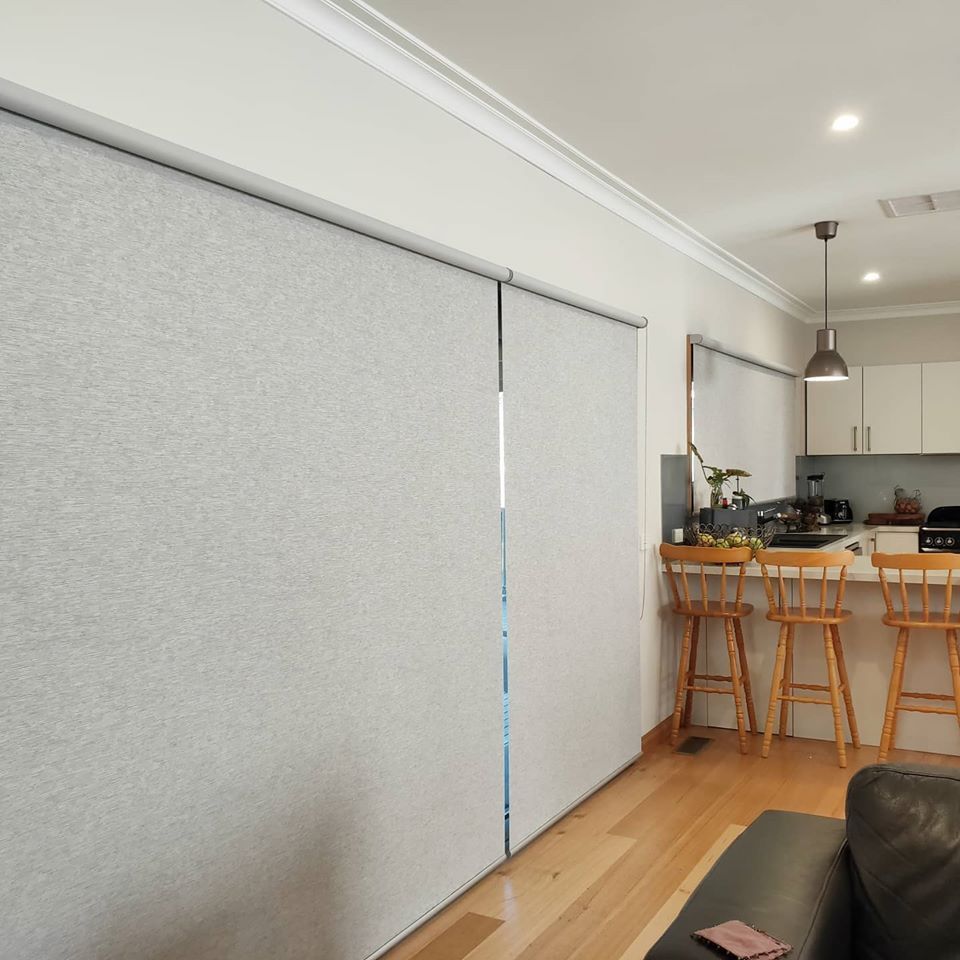 Light Grey Roller Shades Cover Windows in A Bright Kitchen — Alice Mobile Blinds in Ciccone, NT