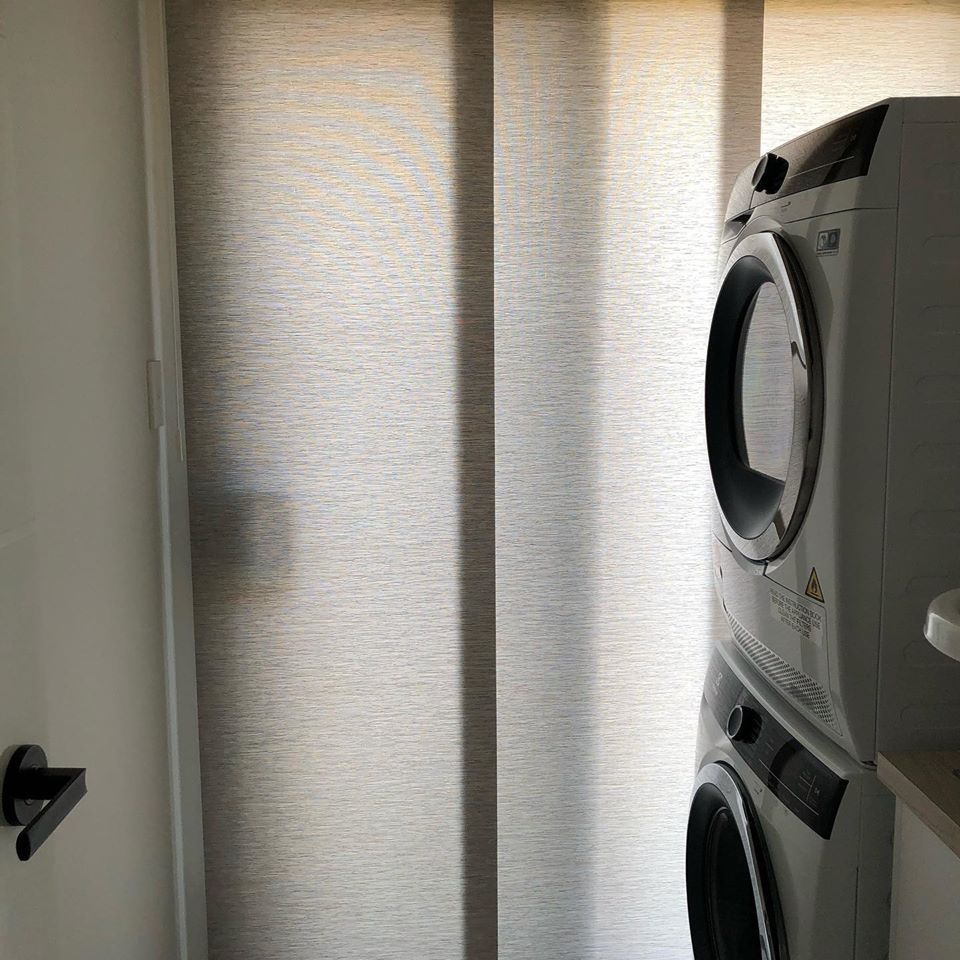Laundry Room with Stacked Washer and A Black Door Handle — Alice Mobile Blinds in Ciccone, NT