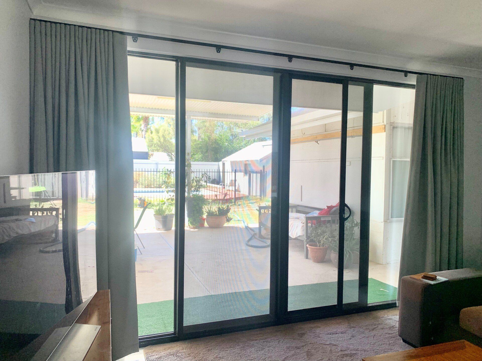 Grey Curtains Frame Sliding Glass Doors — Alice Mobile Blinds in Ciccone, NT