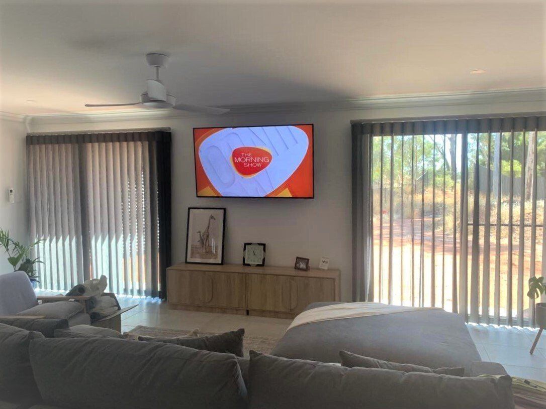 Living Room with Tv on Wall and Window Blinds — Alice Mobile Blinds in Ciccone, NT