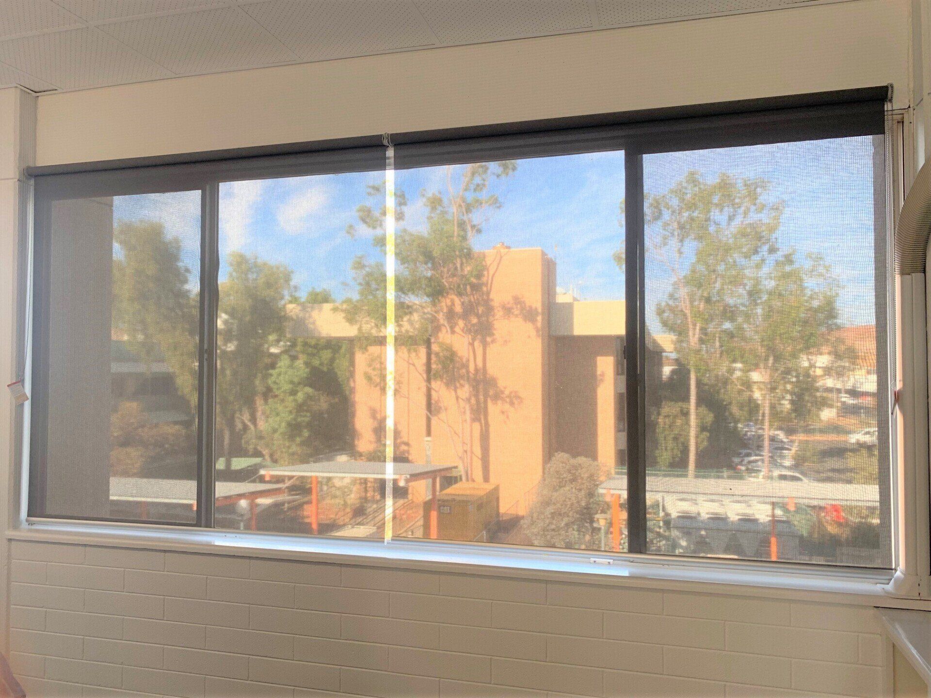 View Through a Mesh Screen Window and A Blue Sky — Alice Mobile Blinds in Ciccone, NT