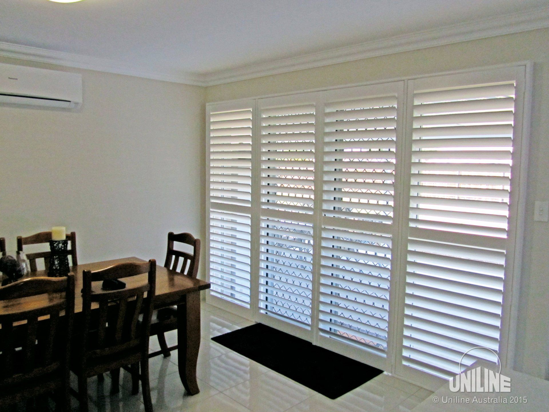 Dining Room with White Shuttered Doors — Alice Mobile Blinds in Ciccone, NT