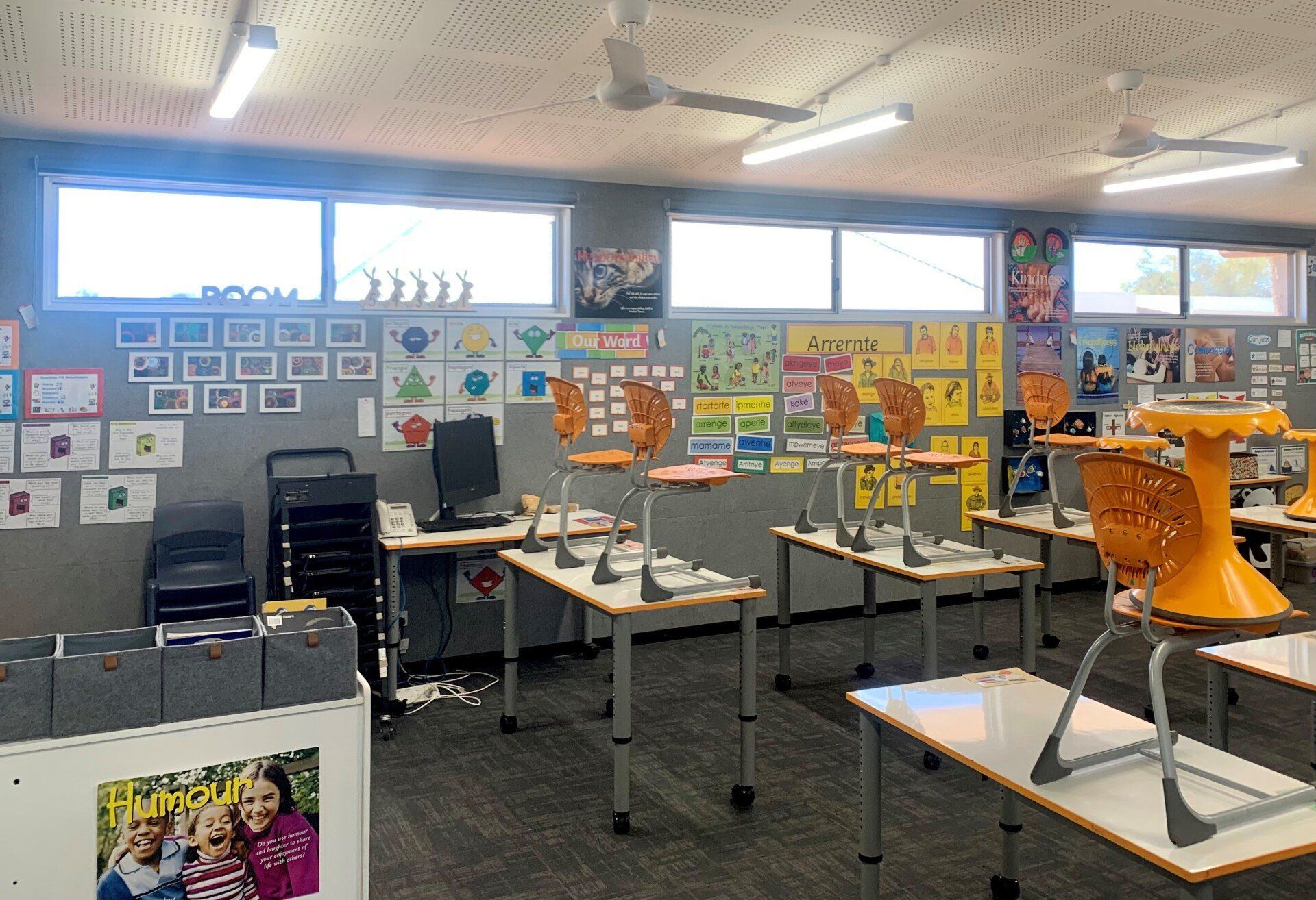 Classroom with Desks, Orange Chairs, Windows and Ceiling Fans — Alice Mobile Blinds in Ciccone, NT