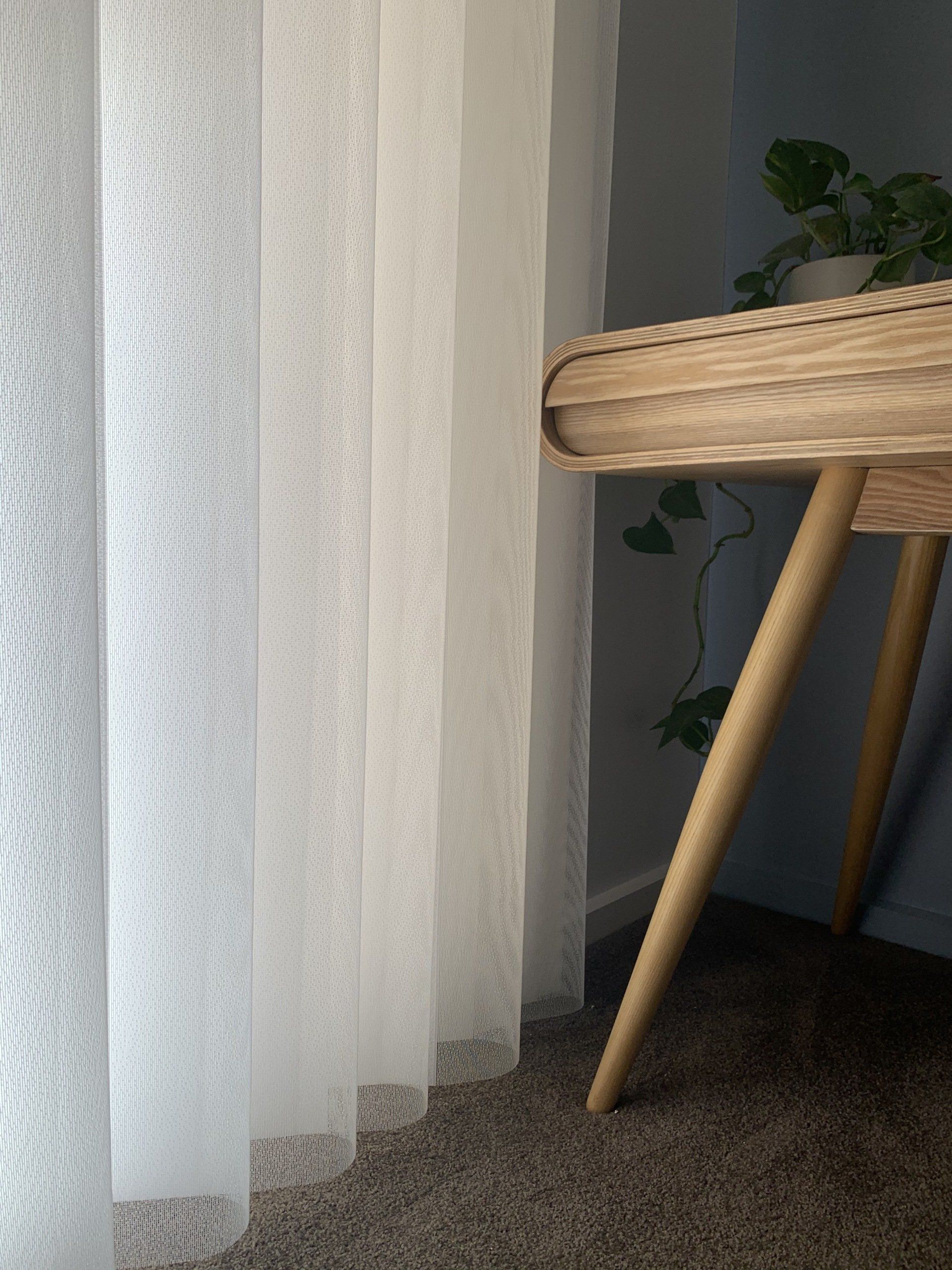 White Sheer Curtains Next to A Wooden Desk with A Plant — Alice Mobile Blinds in Ciccone, NT