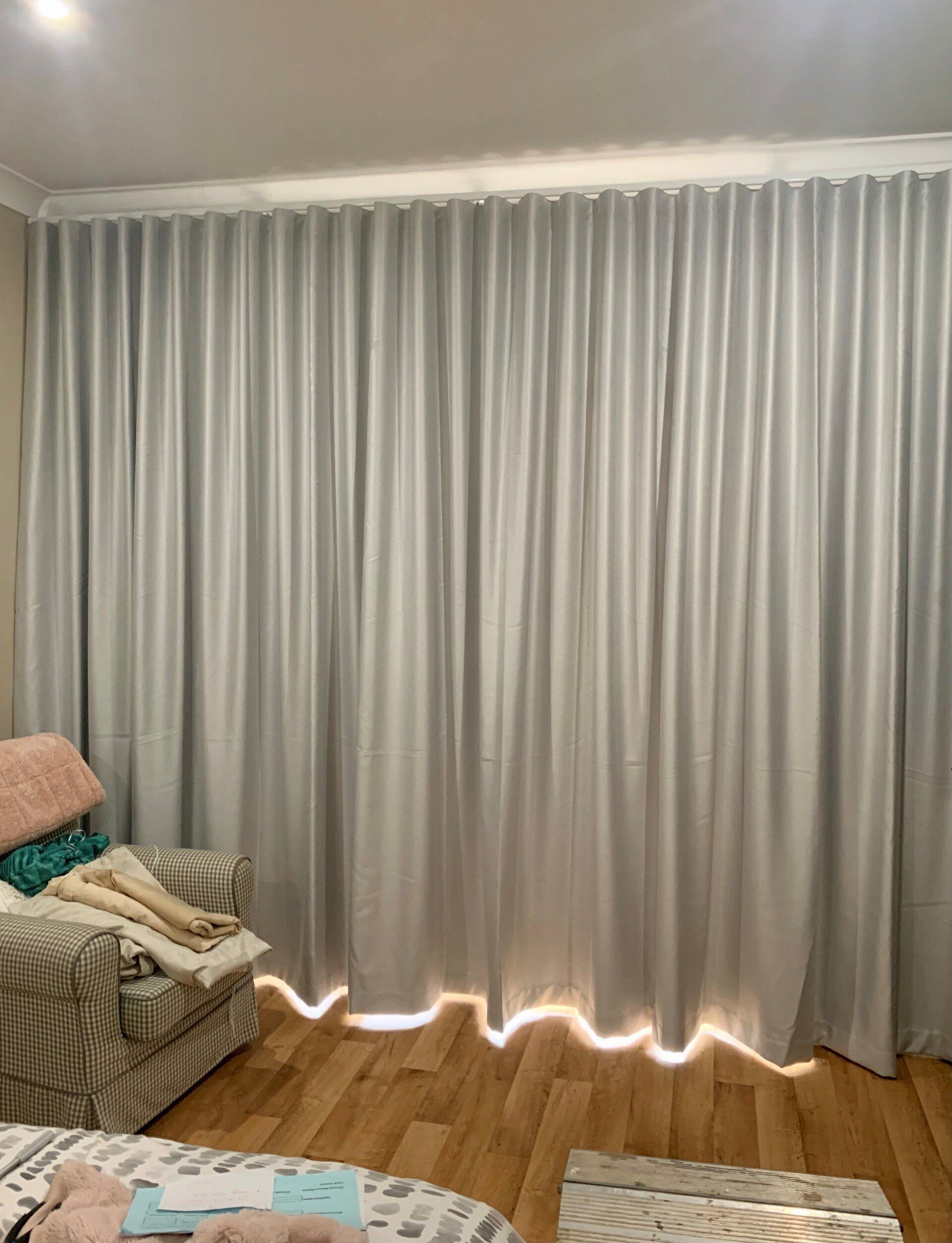 Grey Curtains Hanging in Front of A Window — Alice Mobile Blinds in Ciccone, NT