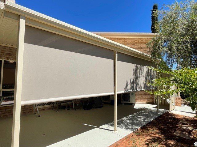 Beige Outdoor Roller Shades Installed on A Patio — Alice Mobile Blinds in Ciccone, NT