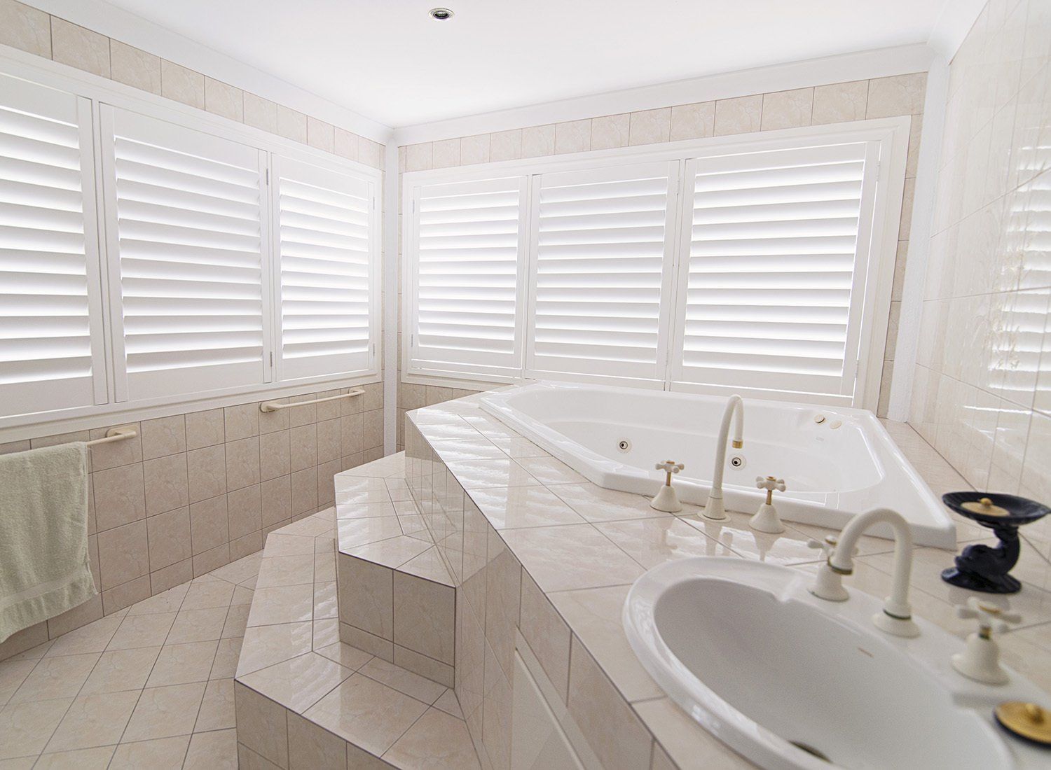 Bathroom with White Shutters a Built-In Tub and A Sink — Alice Mobile Blinds in Ciccone, NT