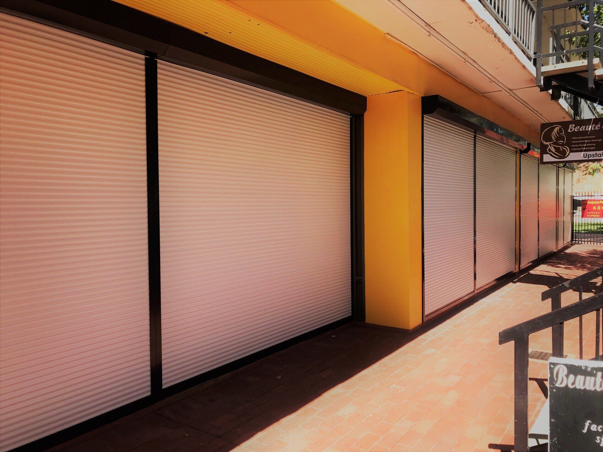 Closed Shopfronts with White Roller Shutters — Alice Mobile Blinds in Ciccone, NT
