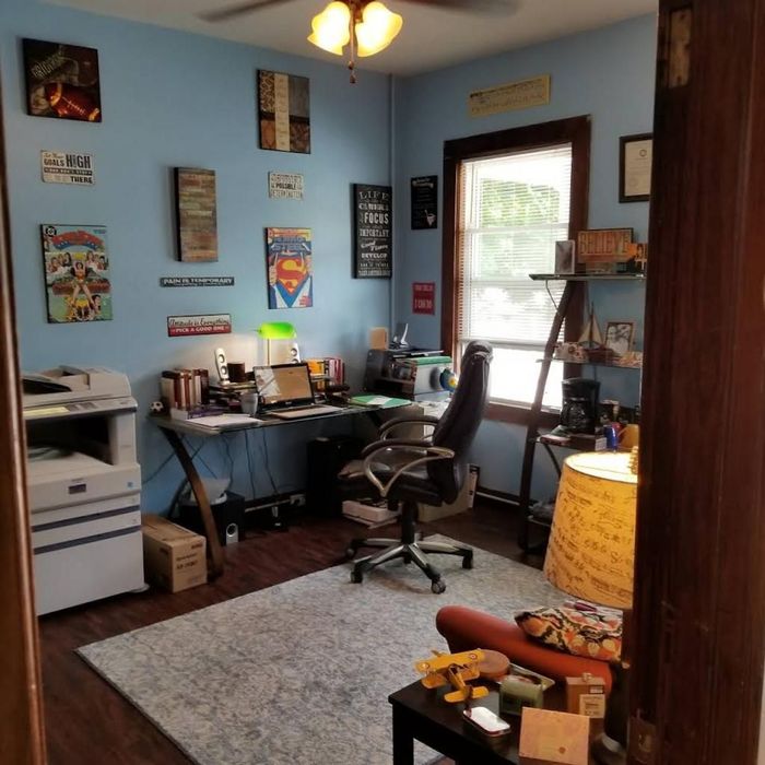 A room with blue walls and a desk and chair
