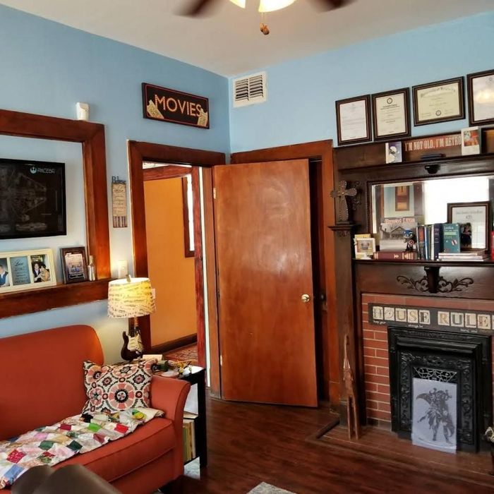 A living room with a sign on the wall that says movies