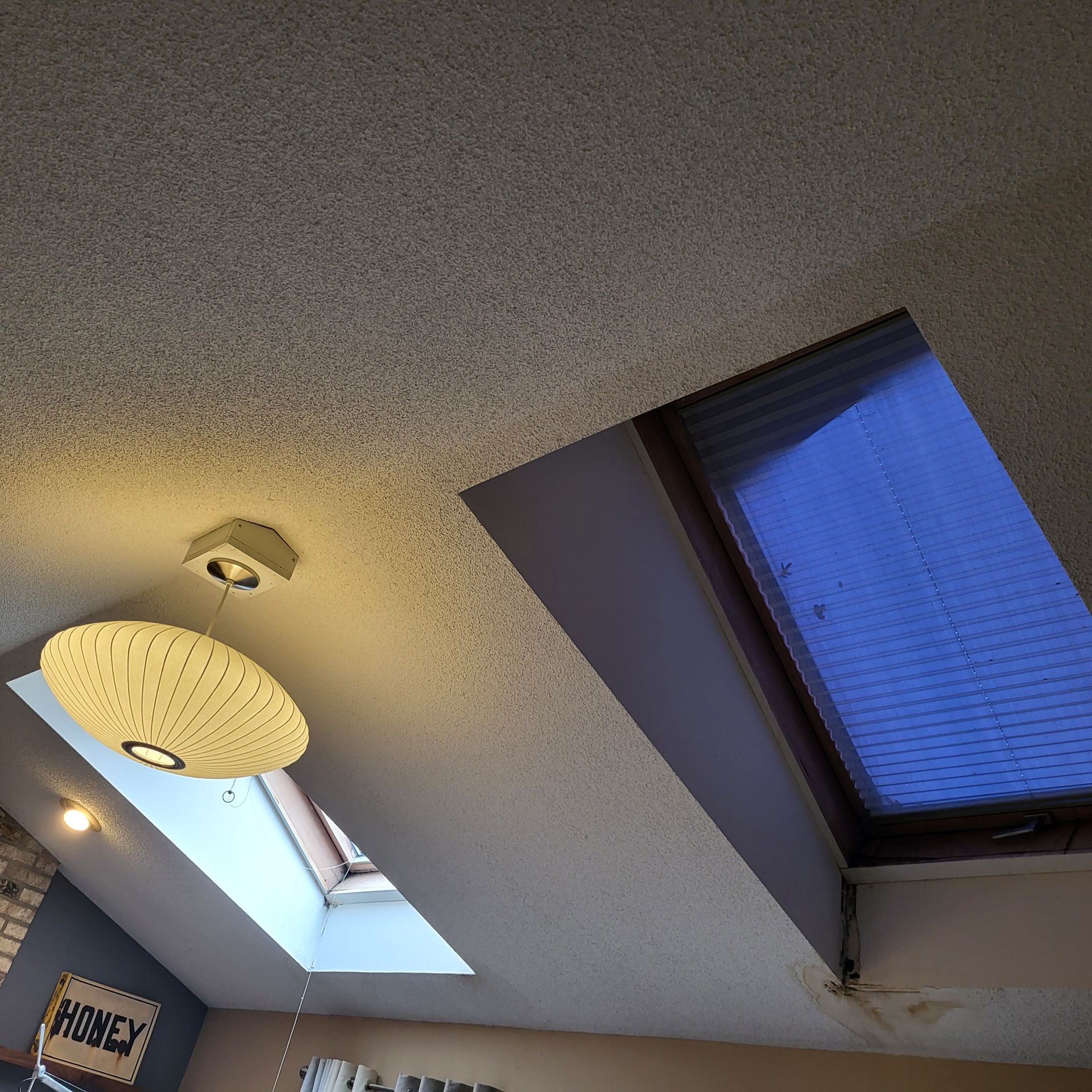 A room with a skylight and a sign that says honey