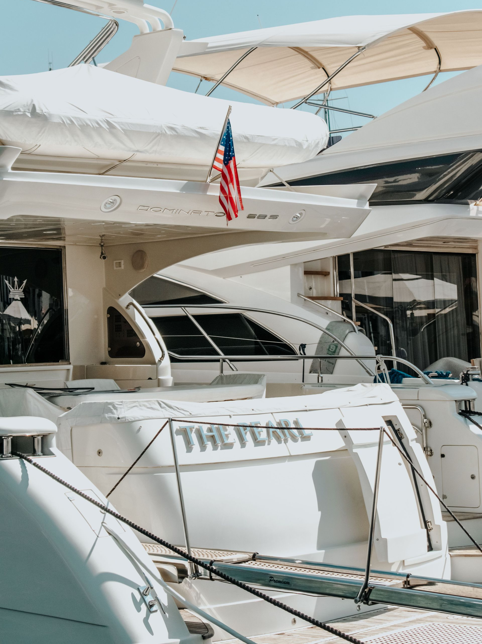 A large yacht is sitting on a dock next to a large ship.