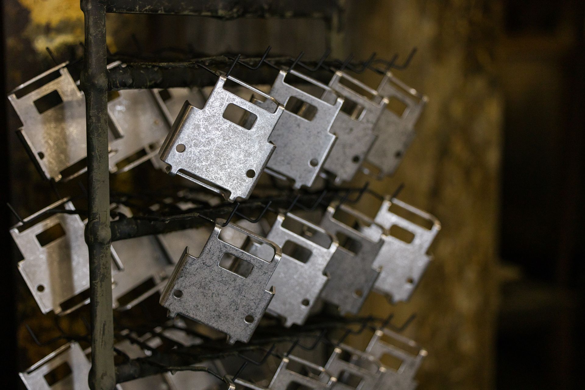 Metal pieces are stacked on top of each other on a rack.