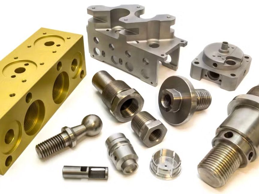A photo of metal screw machined parts on a white surface.