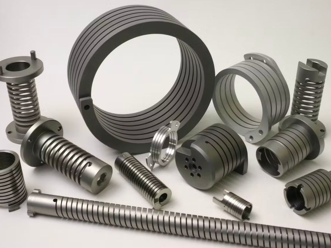 A photo of metal spring manufactured parts on a white surface.