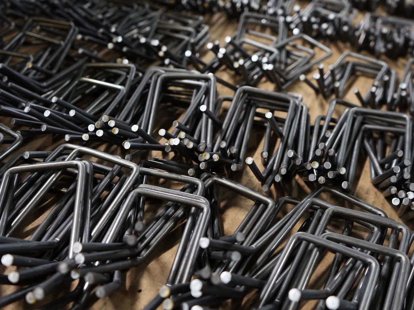 A photo of metal pieces are stacked on top of each other on a table.
