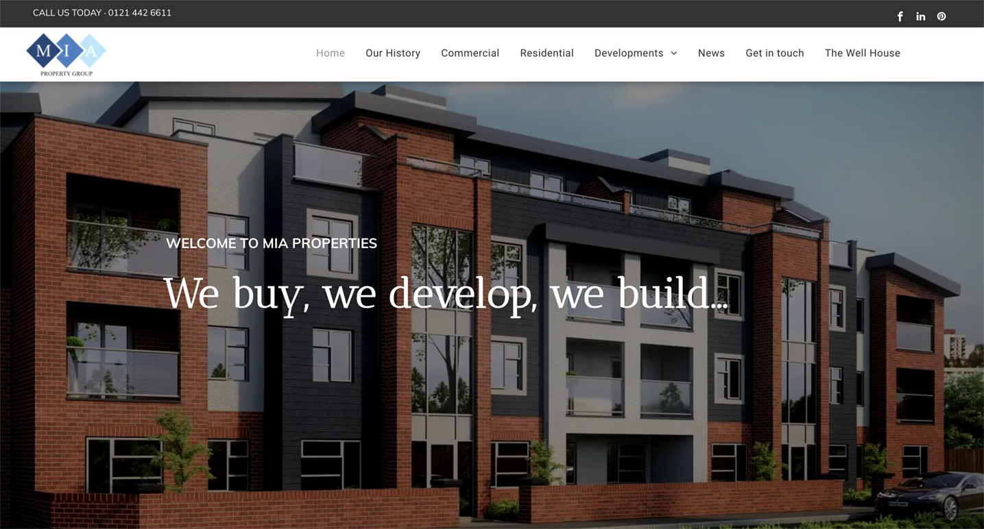 Modern apartment building facade with the company logo, and tagline