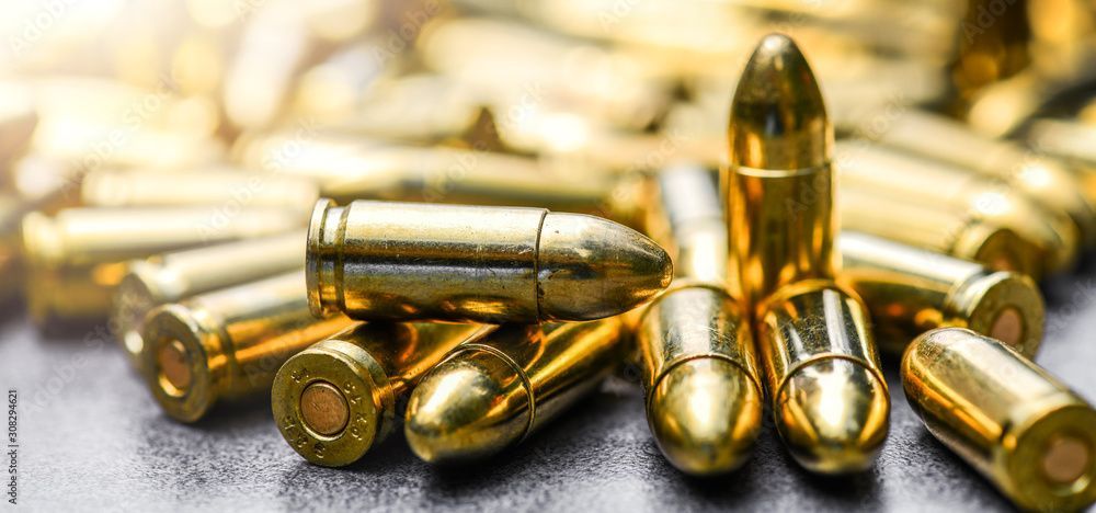 A pile of gold bullets sitting on top of each other on a table.